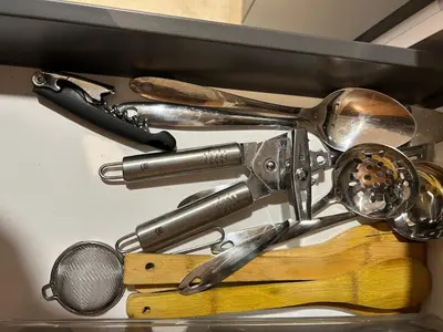 a bunch of kitchen utensils hanging from a shelf at 12th Palm Living Modern Studio - Near Maarif in Casablanca
