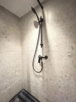 a shower with a shower head in a bathroom at 12th Palm Living Modern Studio - Near Maarif in Casablanca