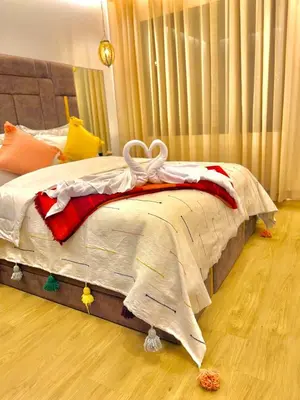 a bed with a blanket on it in a bedroom at AS29 studio luxueux au centre casablanca Tramway Parking free in Casablanca