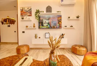 a living room with a vase on the floor at AS29 studio luxueux au centre casablanca Tramway Parking free in Casablanca