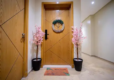 two plants in vases in front of a door at R101-6- Lovely and Spatious apartments in Belvedere near High Speed Train Station in Casablanca