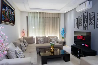 a living room with a couch and a tv at R101-6- Lovely and Spatious apartments in Belvedere near High Speed Train Station in Casablanca