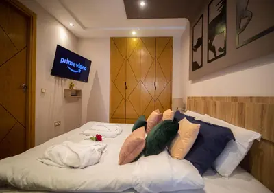 a bed with many pillows on it in a room at R101-6- Lovely and Spatious apartments in Belvedere near High Speed Train Station in Casablanca