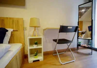a room with a bed and a chair and a lamp at R101-6- Lovely and Spatious apartments in Belvedere near High Speed Train Station in Casablanca