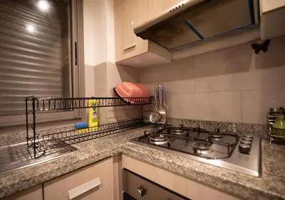 a kitchen counter with a stove and a sink at R101-6- Lovely and Spatious apartments in Belvedere near High Speed Train Station in Casablanca