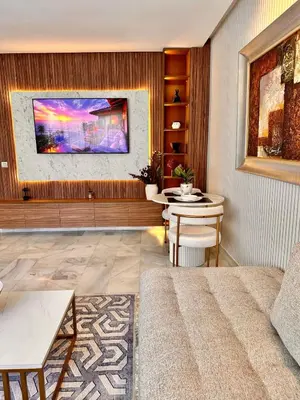 a living room with a couch and a table at Cozy apartment near the sea in Casablanca