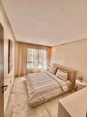 a bedroom with a large bed in front of a window at Cozy apartment near the sea in Casablanca