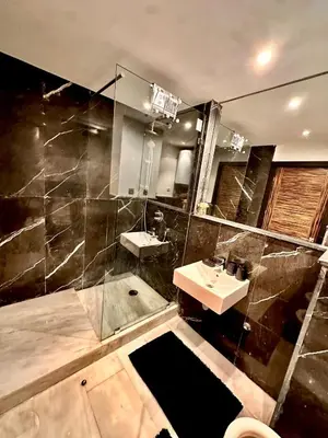 a large bathroom with a sink and a shower at Cozy apartment near the sea in Casablanca