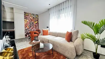 a living room with a couch and a table at Rooftop Pool Studio - By AppartAli in Casablanca