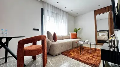 a living room with a couch and a table at Rooftop Pool Studio - By AppartAli in Casablanca