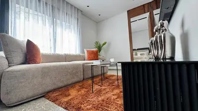 a living room with a couch and a glass table at Rooftop Pool Studio - By AppartAli in Casablanca