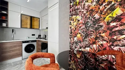 a kitchen with a wall with a colorful wallpaper at Rooftop Pool Studio - By AppartAli in Casablanca