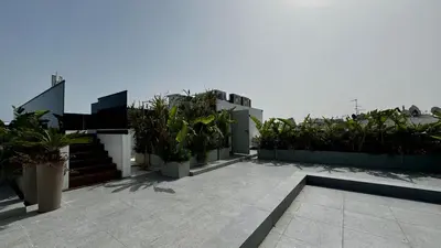 a balcony with potted plants and stairs on a building at Rooftop Pool Studio - By AppartAli in Casablanca