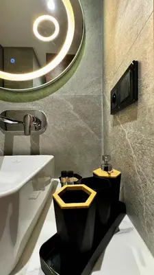 a bathroom with a black and yellow toilet and a sink at Pool in the Sky - By AppartAli in Casablanca