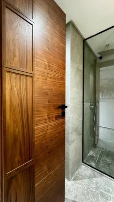 a wooden door in a bathroom with a shower at Pool in the Sky - By AppartAli in Casablanca