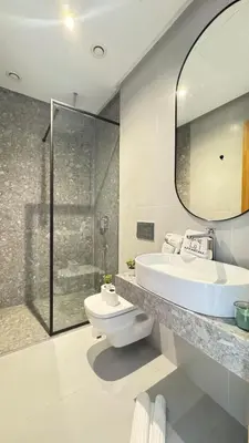 a bathroom with a toilet and a sink and a mirror at The CFC View - By AppartAli in Casablanca