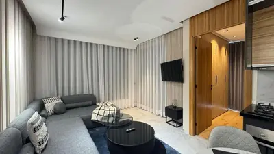 a living room with a couch and a television at The CFC View - By AppartAli in Casablanca