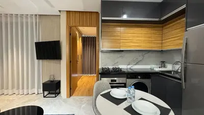 a kitchen with a table and a counter top at The CFC View - By AppartAli in Casablanca