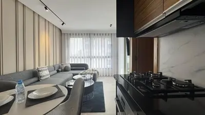 a living room with a couch and a stove at The CFC View - By AppartAli in Casablanca