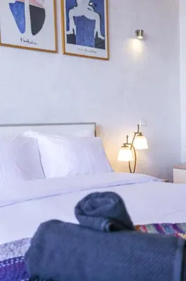 a bedroom with a bed with a blue towel on it at Villa Paquet - Quartier Art Déco in Casablanca