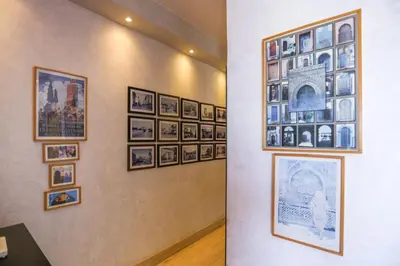 a wall with a bunch of pictures on a wall at Villa Paquet - Quartier Art Déco in Casablanca
