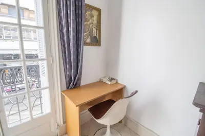a desk and a chair in a room with a window at Spacious Family Apartment in Casablanca in Casablanca