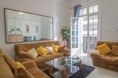 a living room with two couches and a glass table at Spacious Family Apartment in Casablanca in Casablanca