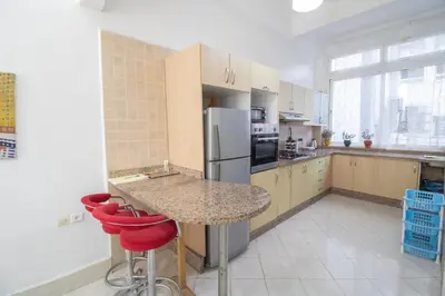 a kitchen with a table and a refrigerator at Spacious Family Apartment in Casablanca in Casablanca