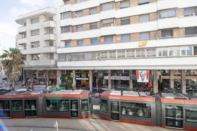 a train is parked in front of a building at Spacious Family Apartment in Casablanca in Casablanca