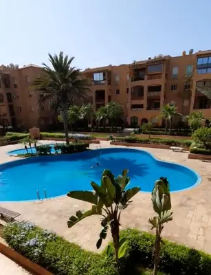 a large swimming pool in front of a building at Ricoflores Mansouria in Mansouria