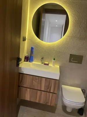 a bathroom with a sink and a toilet with a mirror at Luxoria 2 californie in Casablanca