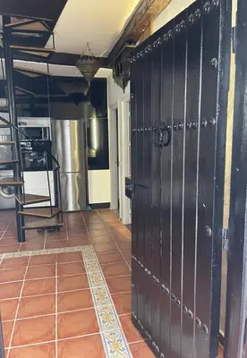 a large black door in a room with a tile floor at Apartment in a beachfront complex in Casablanca