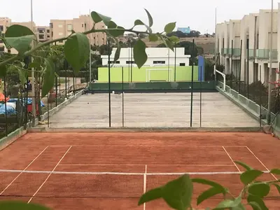 a tennis court with a net on a court at Apartment in a beachfront complex in Casablanca