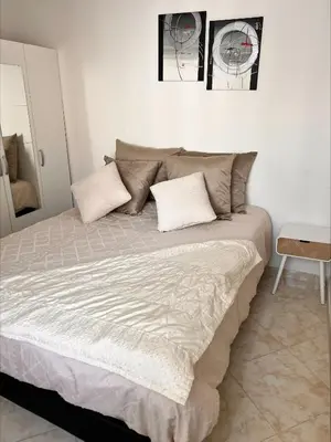 a bedroom with a large bed with two pillows at BOUZNIKA PLAGe in Bouznika