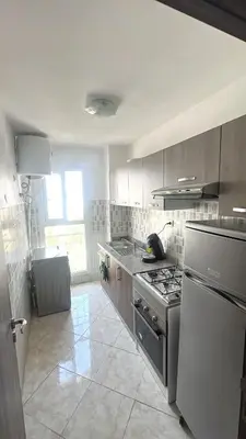 a kitchen with a stove and a sink in it at BOUZNIKA PLAGe in Bouznika