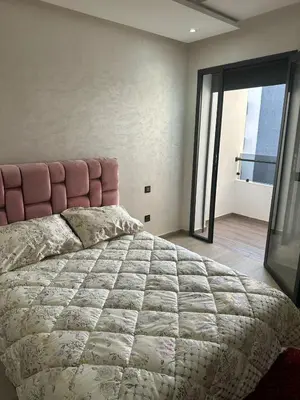 a bedroom with a large bed with a large window at Appartement à Témara - Élégance et confort in Temara