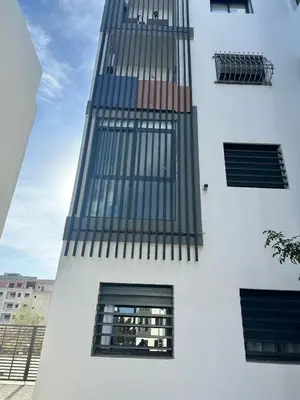 a tall white building with windows on the side of it at Appartement à Témara - Élégance et confort in Temara
