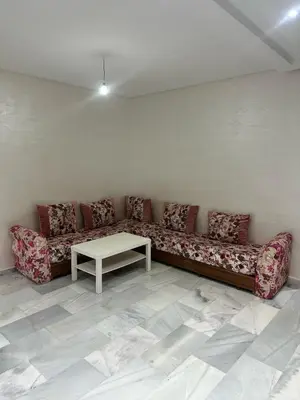 a living room with a couch and a table at Appartement à Témara - Élégance et confort in Temara