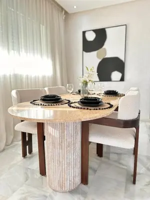 a dining room with a table and chairs at Luxury Beachview Apartment La siesta beach resort in Mohammedia