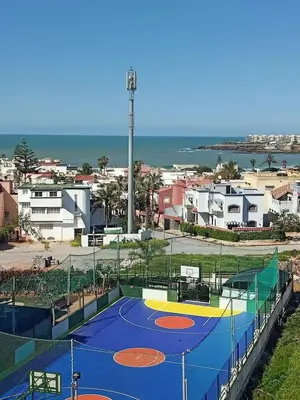 a tennis court in front of a city at Luxury Beachview Apartment La siesta beach resort in Mohammedia