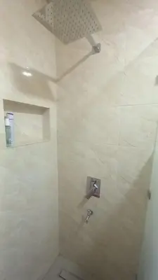 a bathroom with a shower with a sink at Le Refuge in Temara