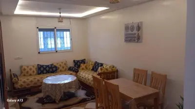 a living room with a couch and a table at Le Refuge in Temara