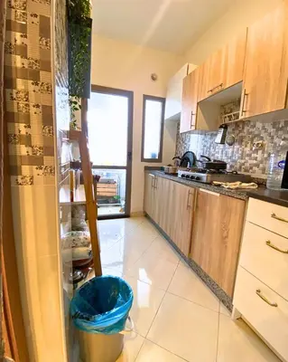 a kitchen with a blue bucket in the middle of it at Appartement Calme à Mohammadia - Séjour Agréable in Mohammedia