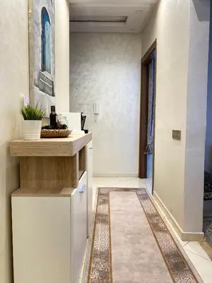 a kitchen with a counter top and a hallway at Appartement Calme à Mohammadia - Séjour Agréable in Mohammedia