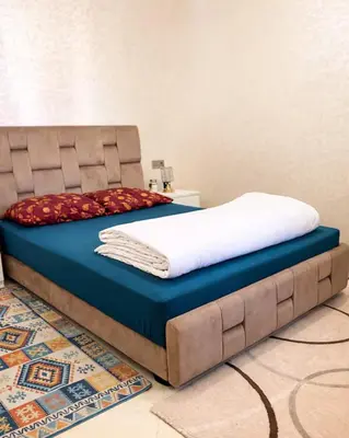 a bed sitting on top of a blue mattress at Appartement Calme à Mohammadia - Séjour Agréable in Mohammedia