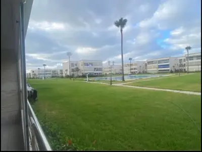 a view from a window of a field with buildings at appartement ola blanca 2 in Dar Hamida