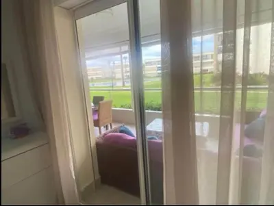 a room with a window with a chair and a table at appartement ola blanca 2 in Dar Hamida