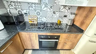 a kitchen with black and white tile on the wall at La Casa in Tamaris