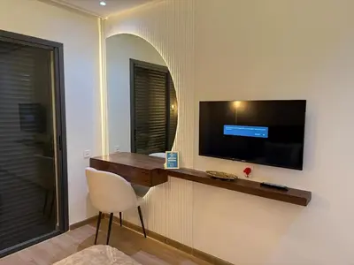a room with a desk with a television and a chair at La Casa in Tamaris