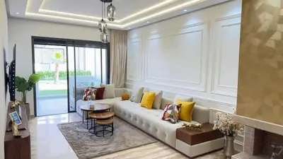 a living room with a white couch with yellow pillows at La Casa in Tamaris